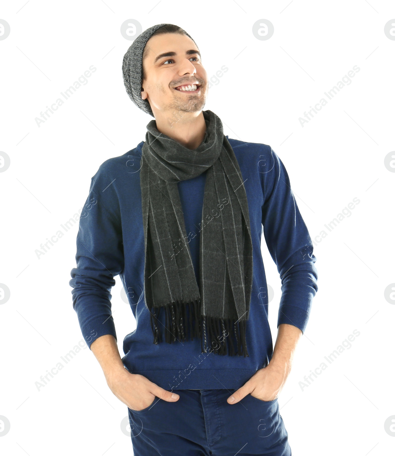 Photo of Portrait of happy young man in warm clothing on white background. Ready for winter vacation