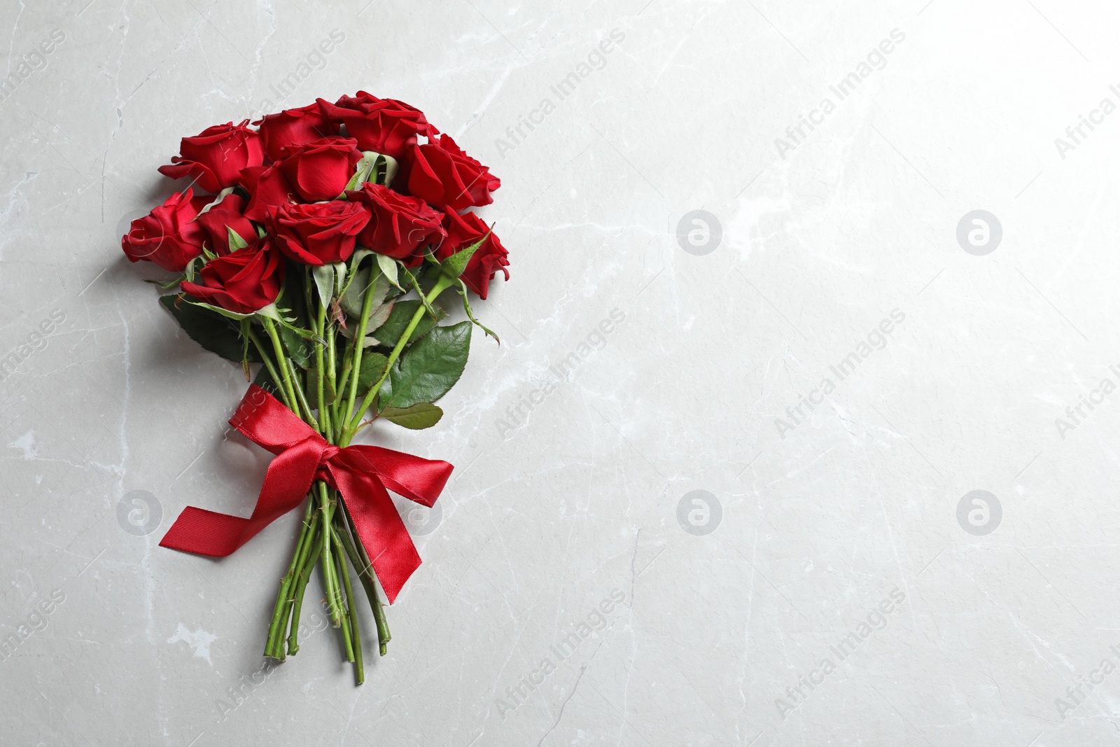 Photo of Beautiful red rose flowers on light background, top view