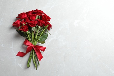 Photo of Beautiful red rose flowers on light background, top view