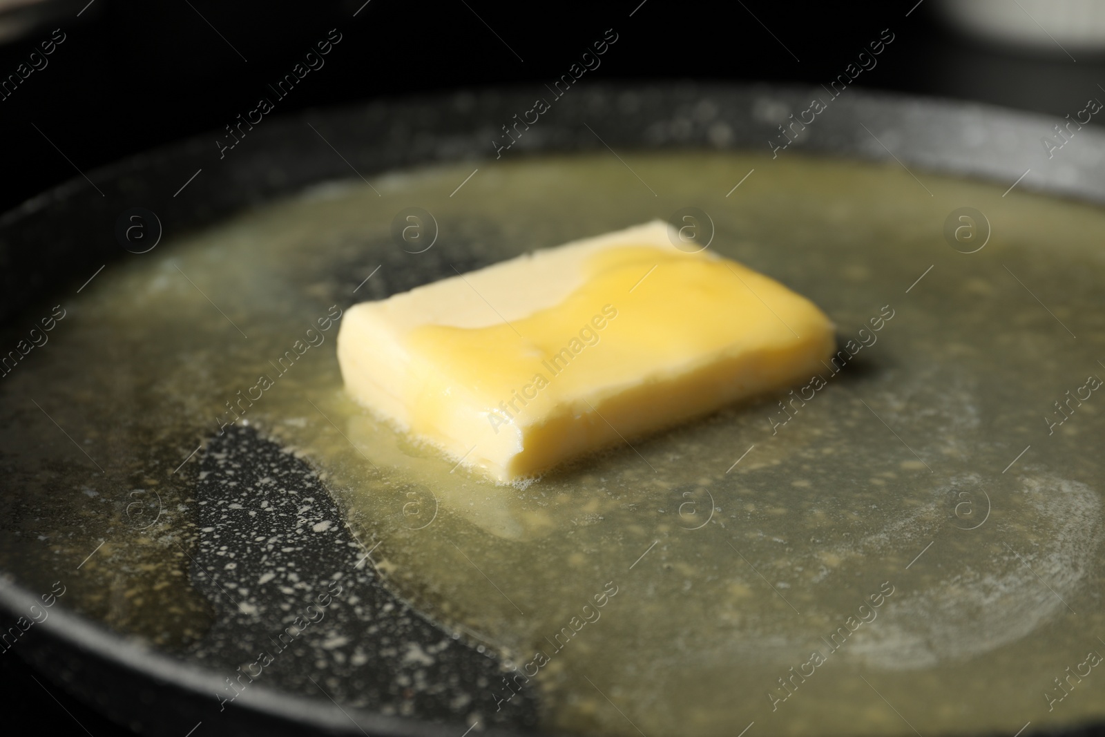 Photo of Melting butter in frying pan, closeup view