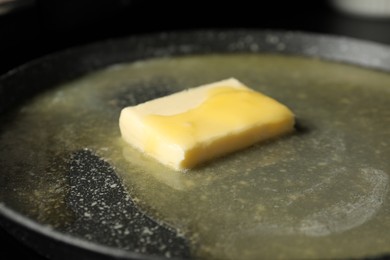 Photo of Melting butter in frying pan, closeup view