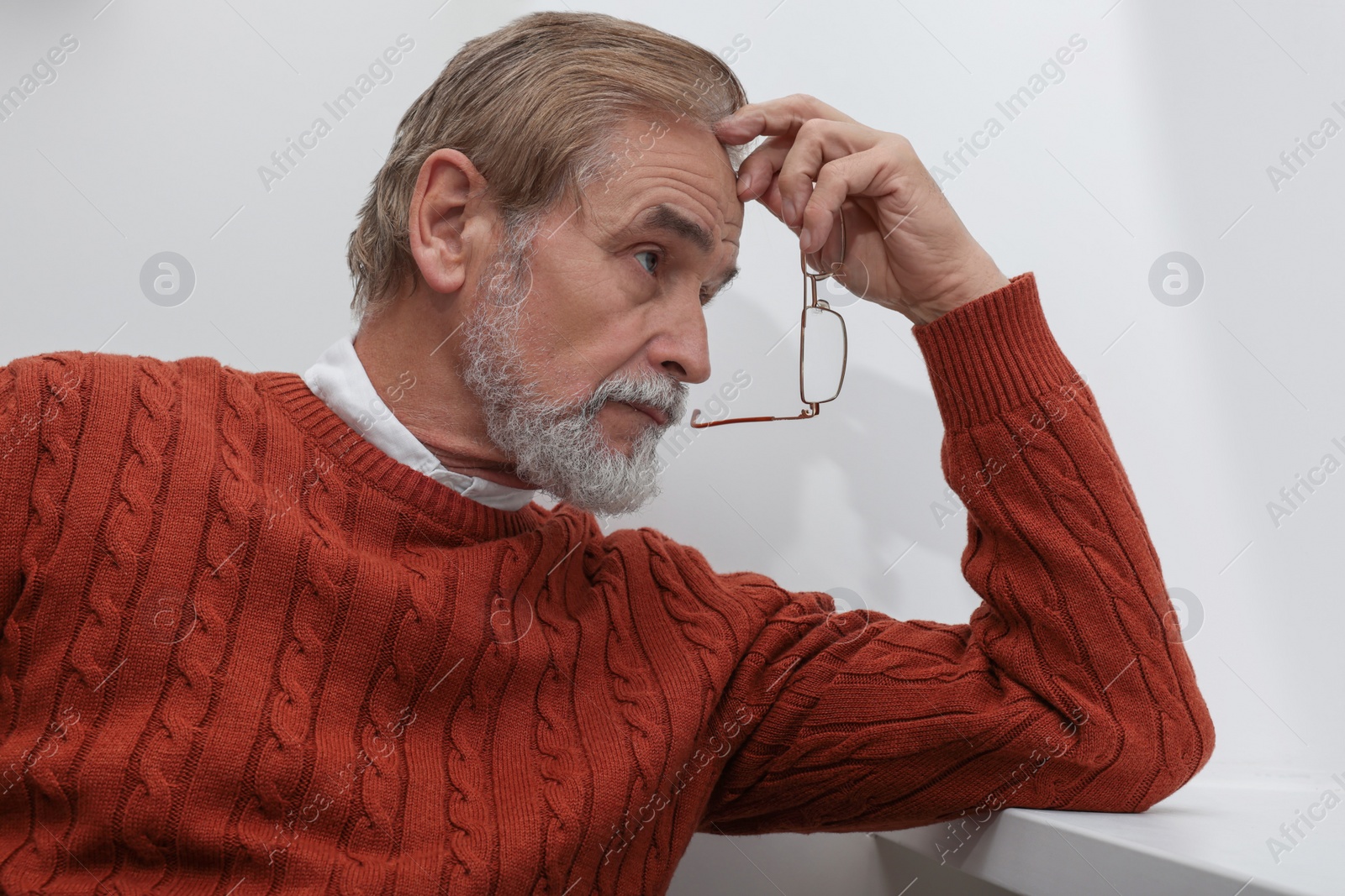 Photo of Upset senior man at home. Loneliness concept