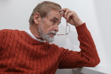 Photo of Upset senior man at home. Loneliness concept