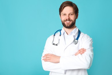 Photo of Doctor or medical assistant (male nurse) with stethoscope on turquoise background. Space for text