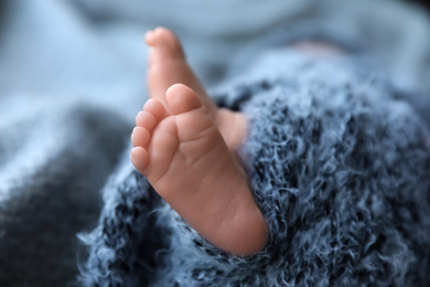 Newborn baby lying on blanket, closeup of legs