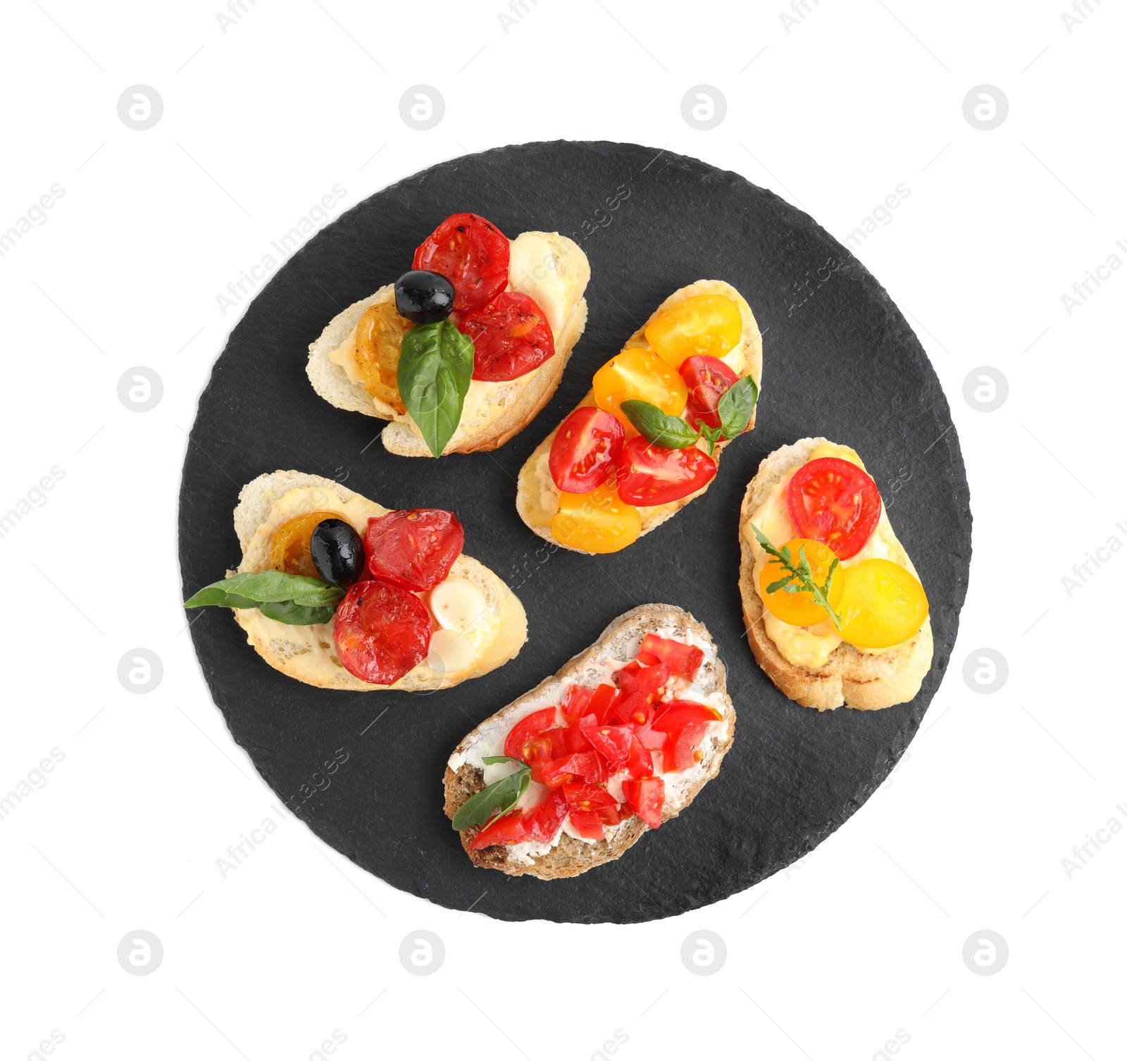 Photo of Slate plate of delicious tomato bruschettas on white background, top view