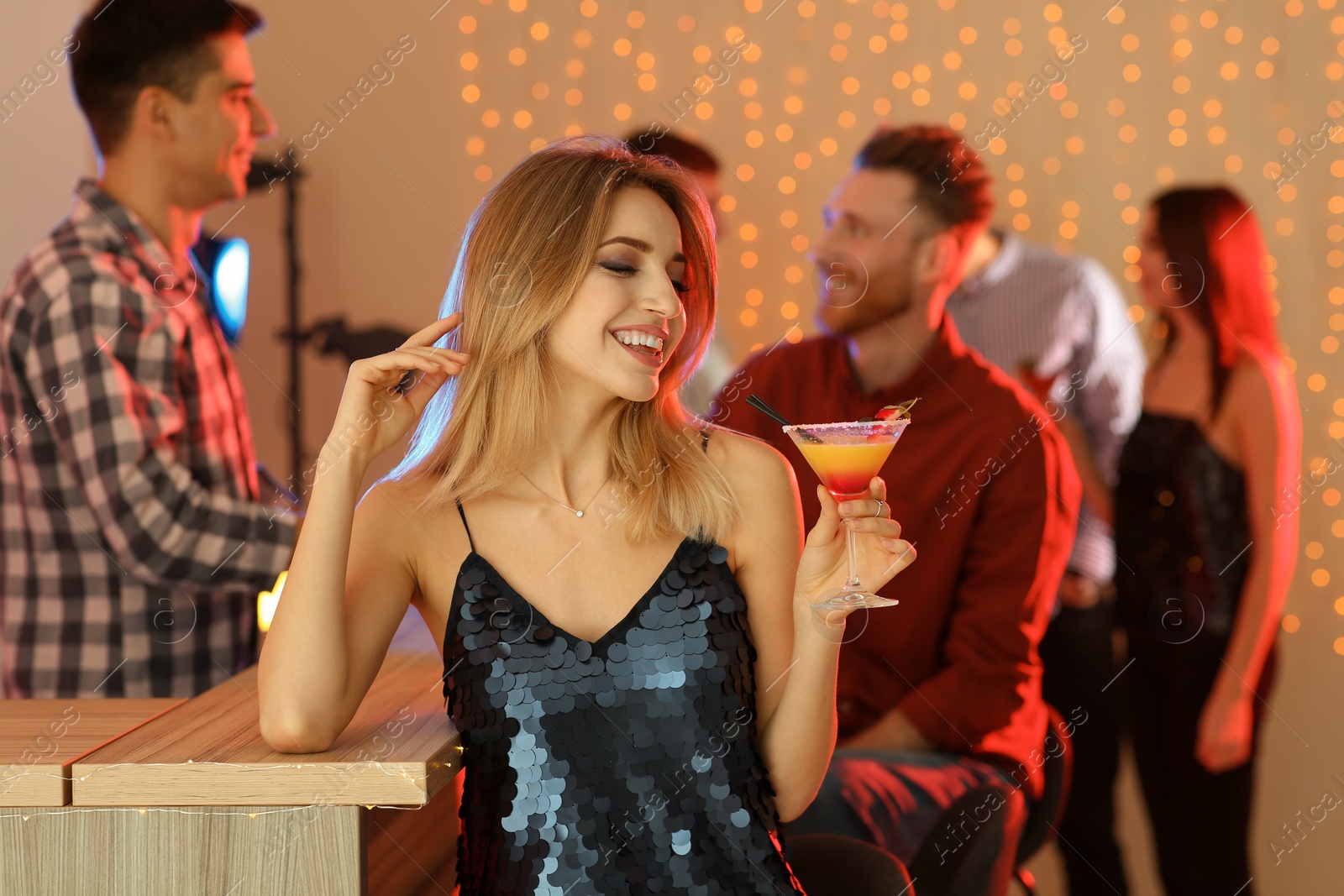 Photo of Beautiful young woman with glass of martini cocktail in bar