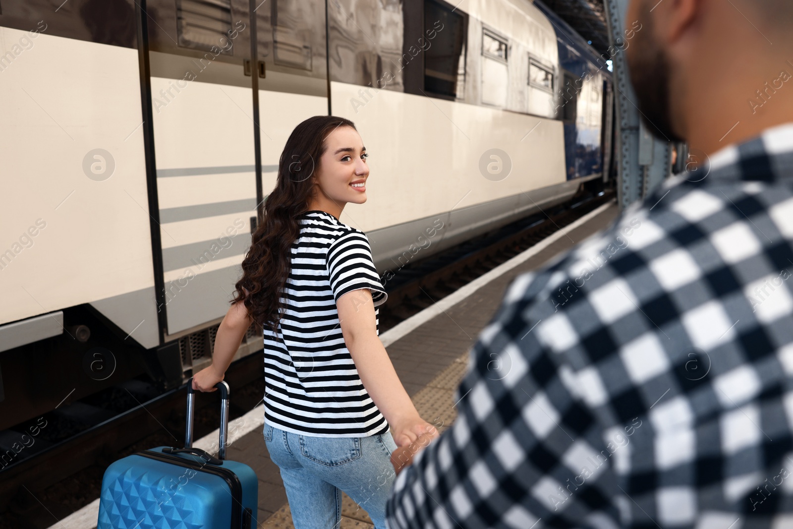 Photo of Long-distance relationship. Couple walking on platform of railway station