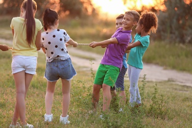 Cute little children playing outdoors at sunset