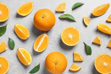 Flat lay composition with fresh oranges on grey background