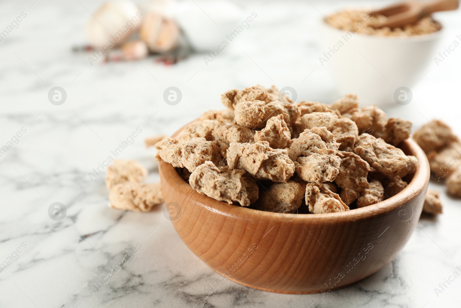 Photo of Dried soy meat on white marble table, closeup