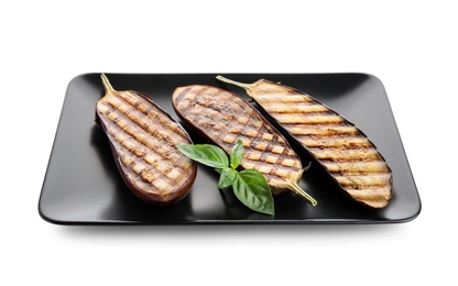 Photo of Delicious grilled eggplant halves with basil isolated on white