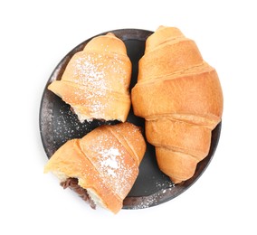 Photo of Tasty croissants with chocolate and sugar powder on white background, top view