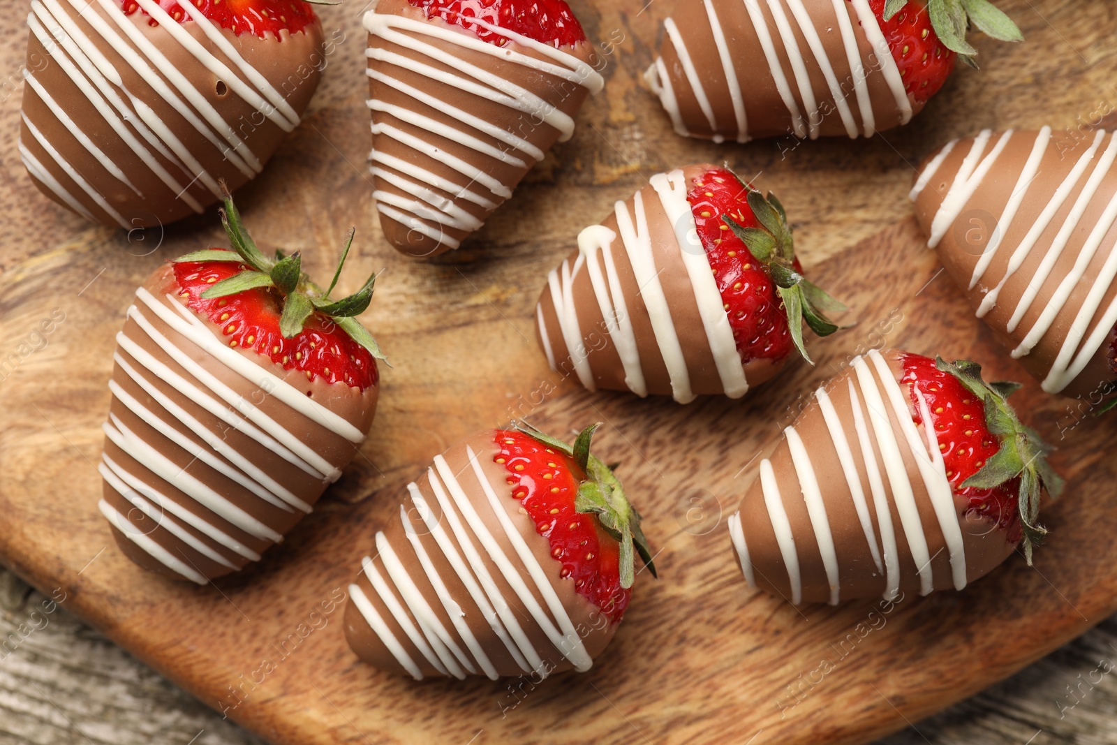 Photo of Delicious chocolate covered strawberries on wooden table, top view