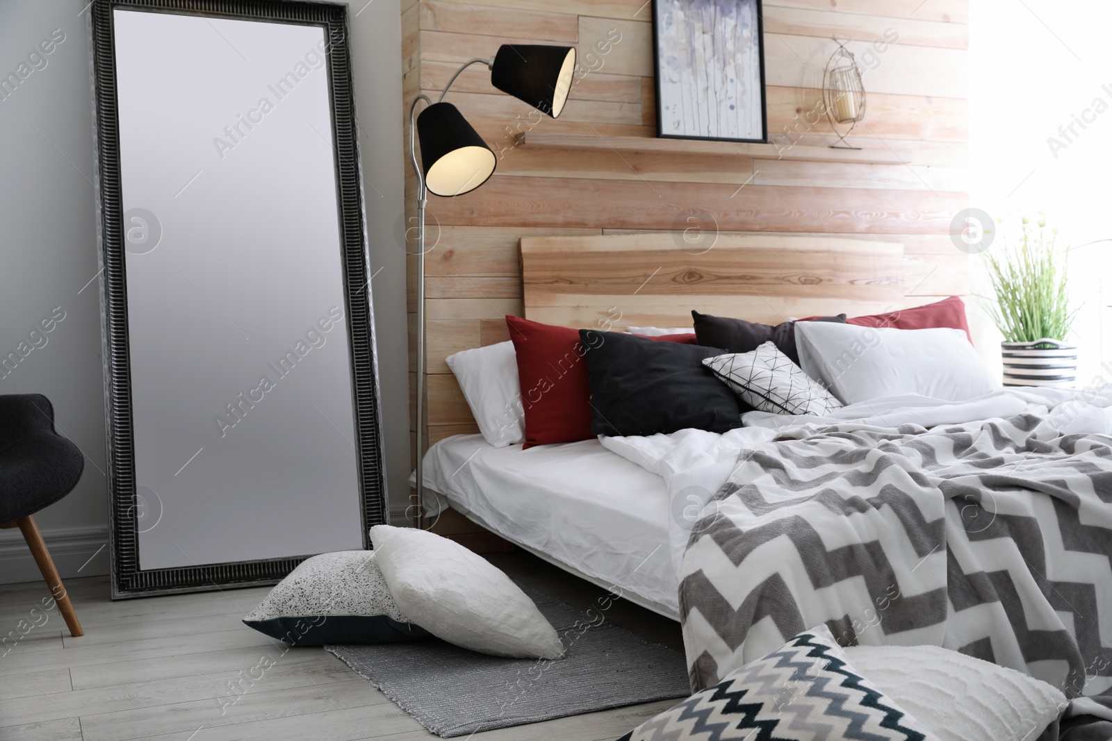 Photo of Different pillows on bed in room. Idea for interior decor