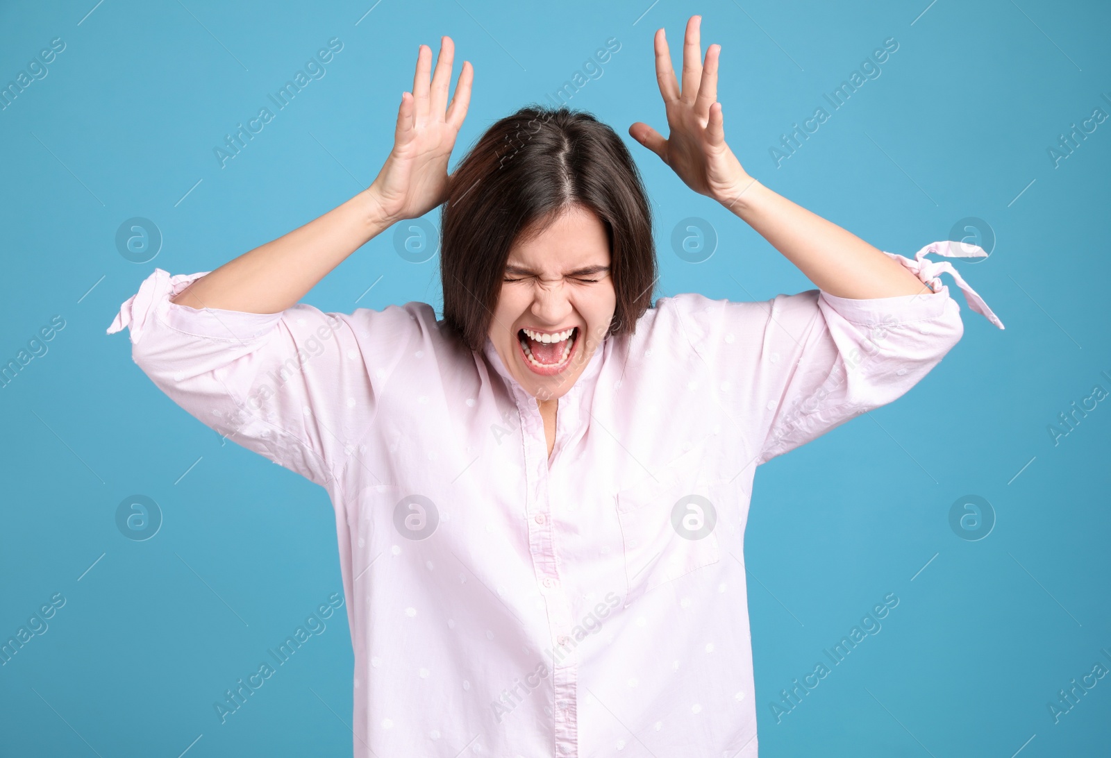 Photo of Portrait of stressed young woman on light blue background