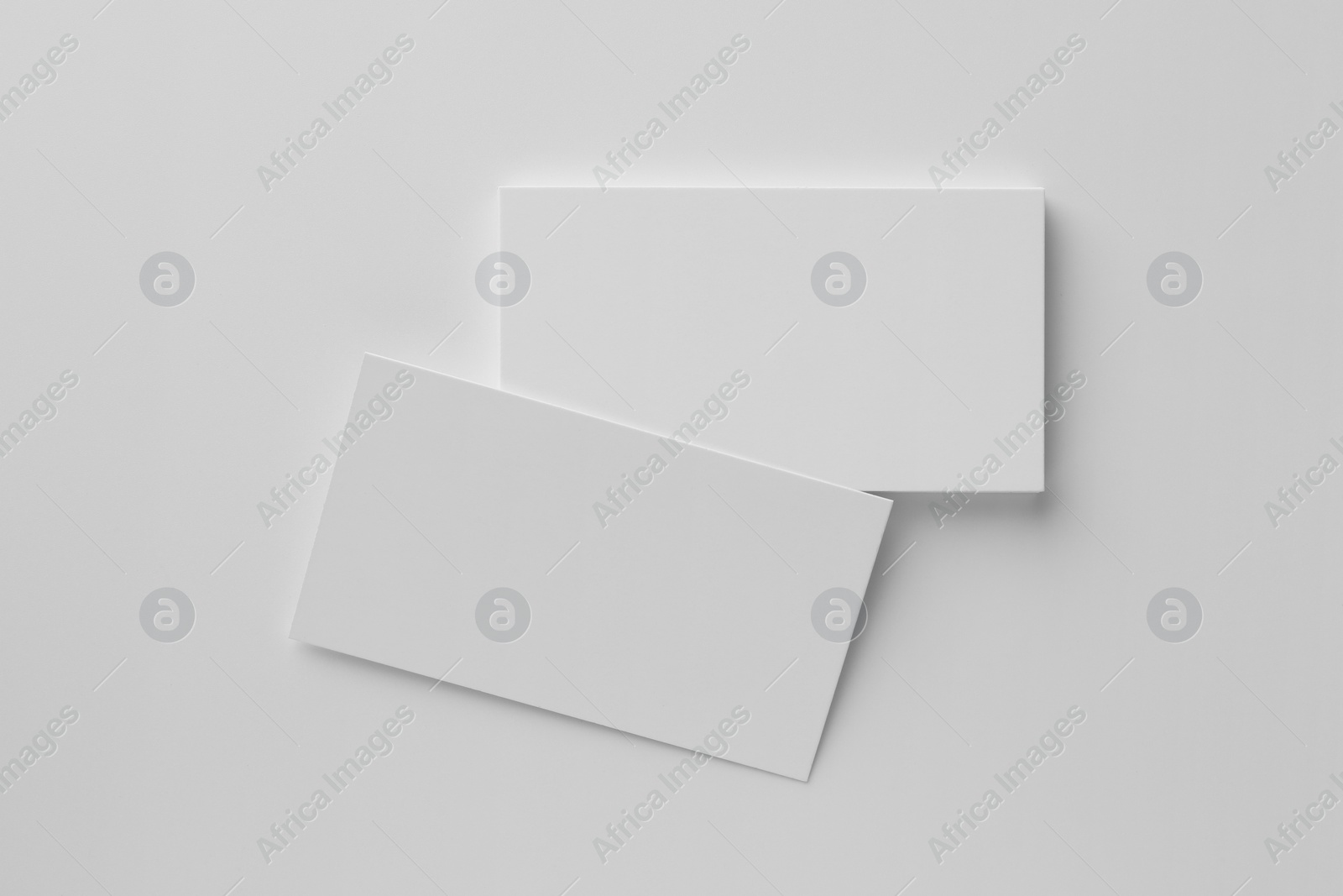 Photo of Blank business cards on white background, top view. Mockup for design