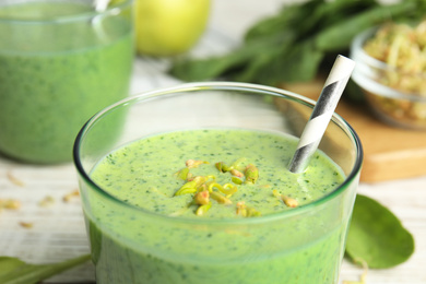 Photo of Green buckwheat smoothie on white table, closeup