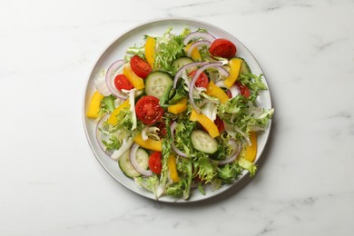 Tasty fresh vegetarian salad on white marble table, top view