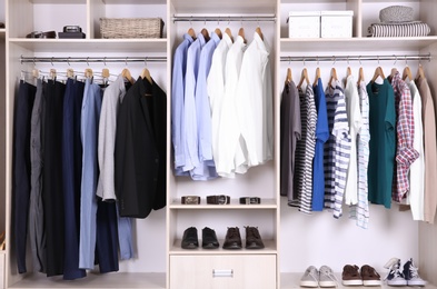 Photo of Large wardrobe with different clothes and shoes