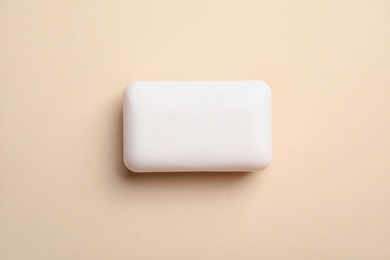 Photo of Soap bar on color background, top view