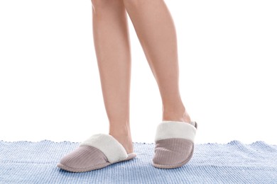 Photo of Woman in warm soft slippers on white background, closeup