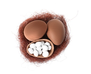 Delicious chocolate Easter eggs on white background, top view