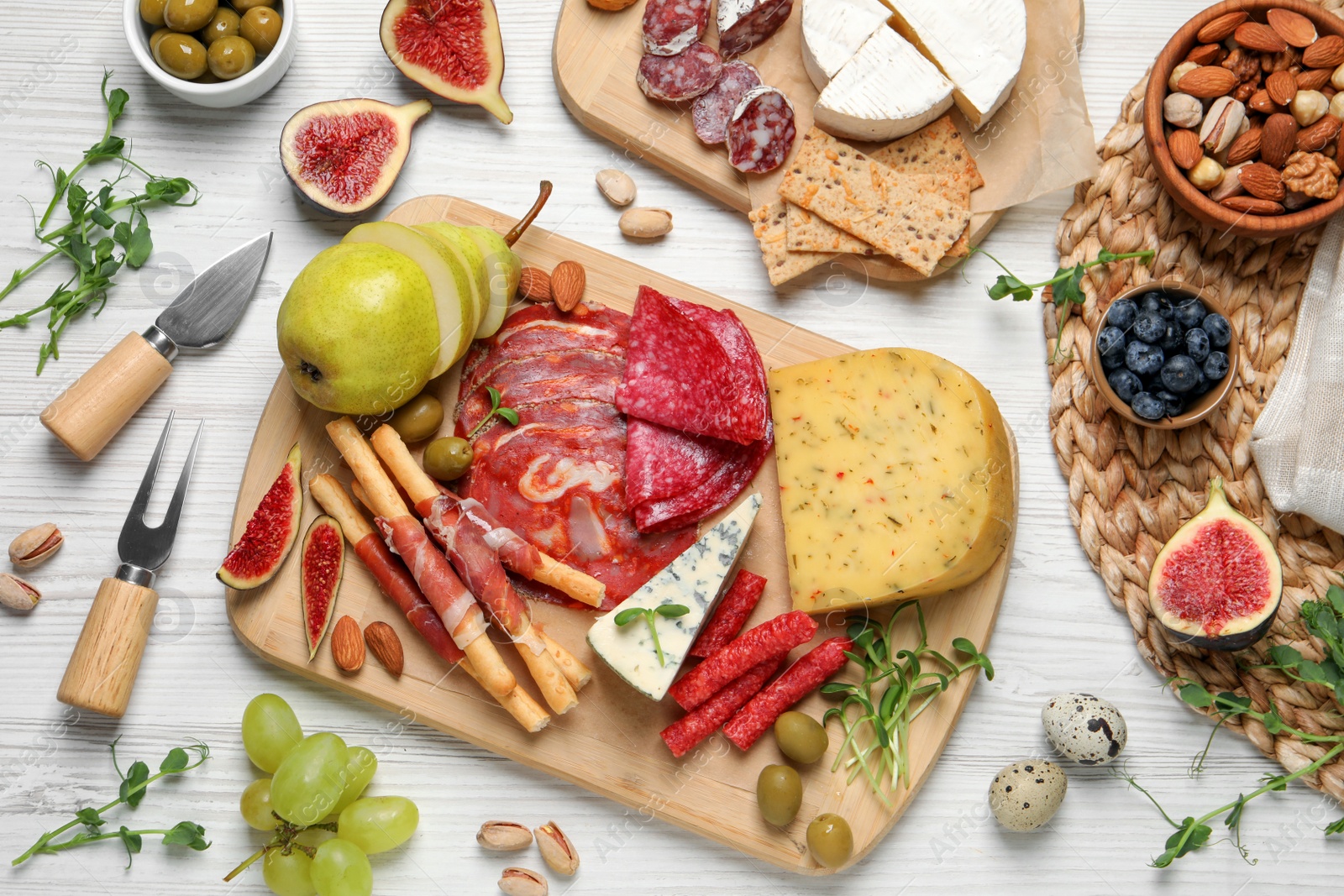 Photo of Set of different delicious appetizers served on white wooden table, flat lay