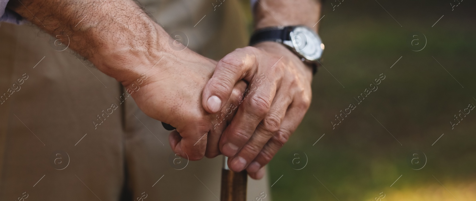Image of Senior man with walking cane outdoors, closeup. Banner design with space for text