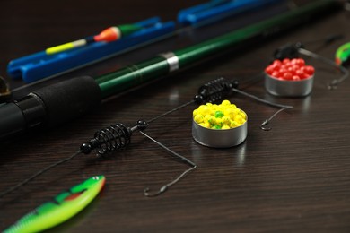 Photo of Fishing tackle on dark wooden background, closeup