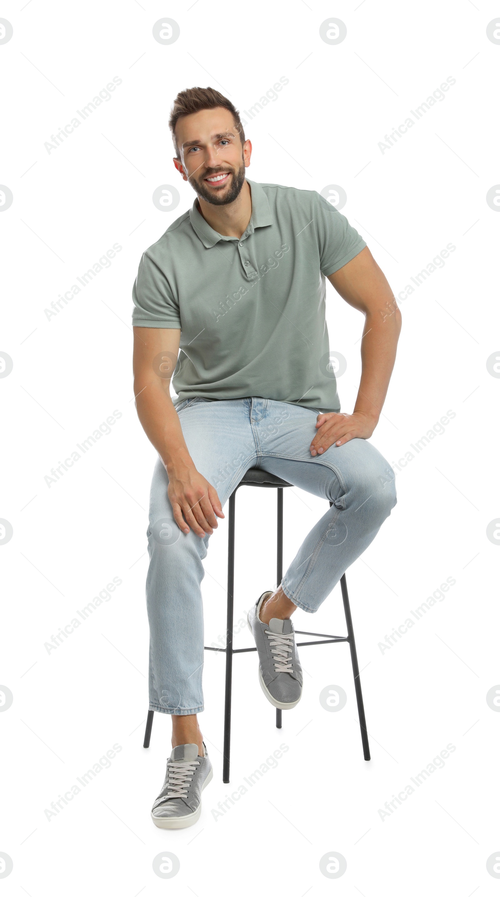 Photo of Handsome man sitting on stool against white background