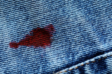 Stain of red ink on jeans, closeup