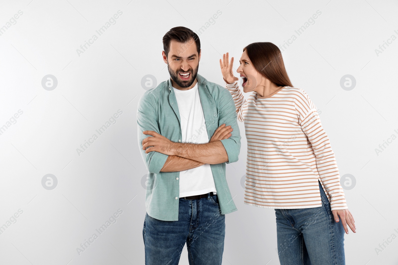 Photo of Couple quarreling on light background. Relationship problems