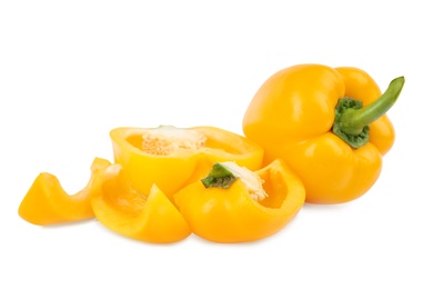 Photo of Whole and cut yellow bell peppers isolated on white