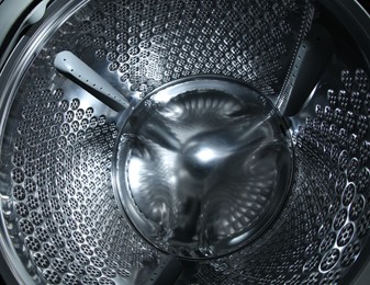 Empty washing machine drum, closeup view. Laundry day