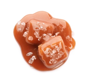 Photo of Caramel candies under tasty sauce with salt isolated on white, top view