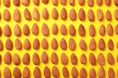 Photo of Composition with organic almond nuts on color background, top view