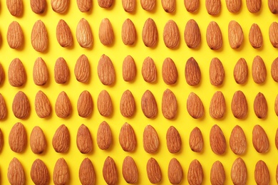 Composition with organic almond nuts on color background, top view