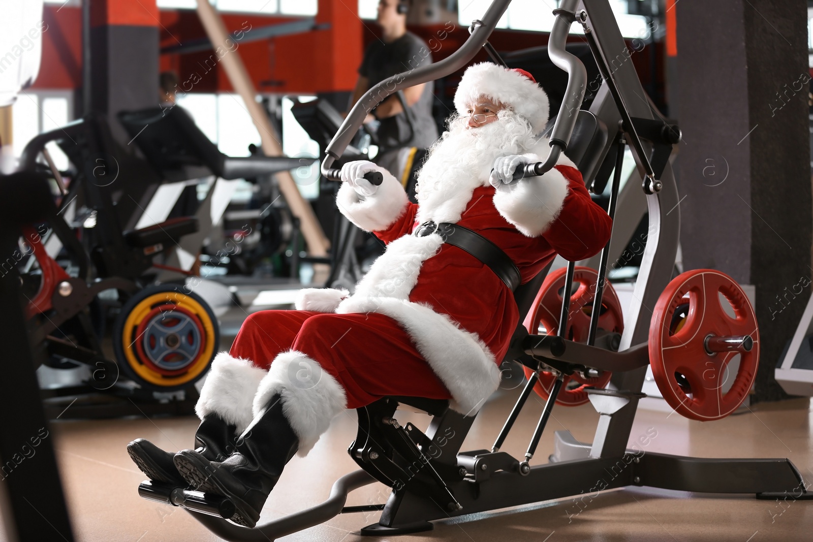 Photo of Authentic Santa Claus training in modern gym