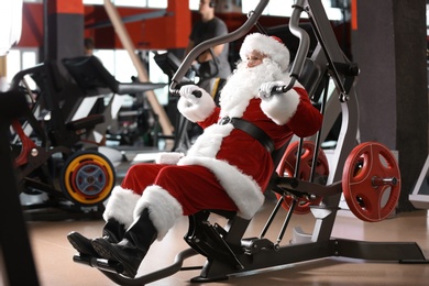 Photo of Authentic Santa Claus training in modern gym