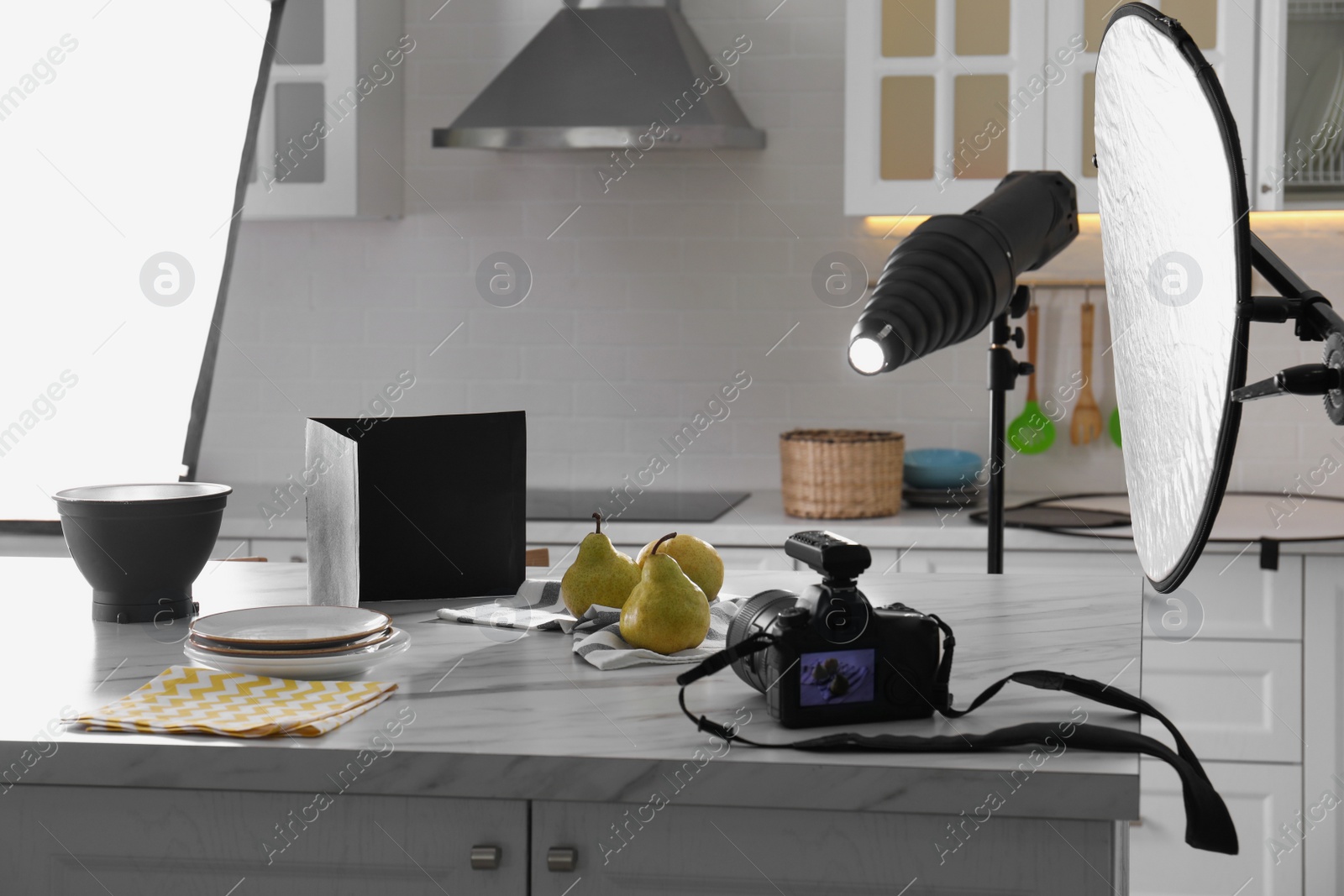 Photo of Professional equipment and many pears on table in kitchen. Food photo