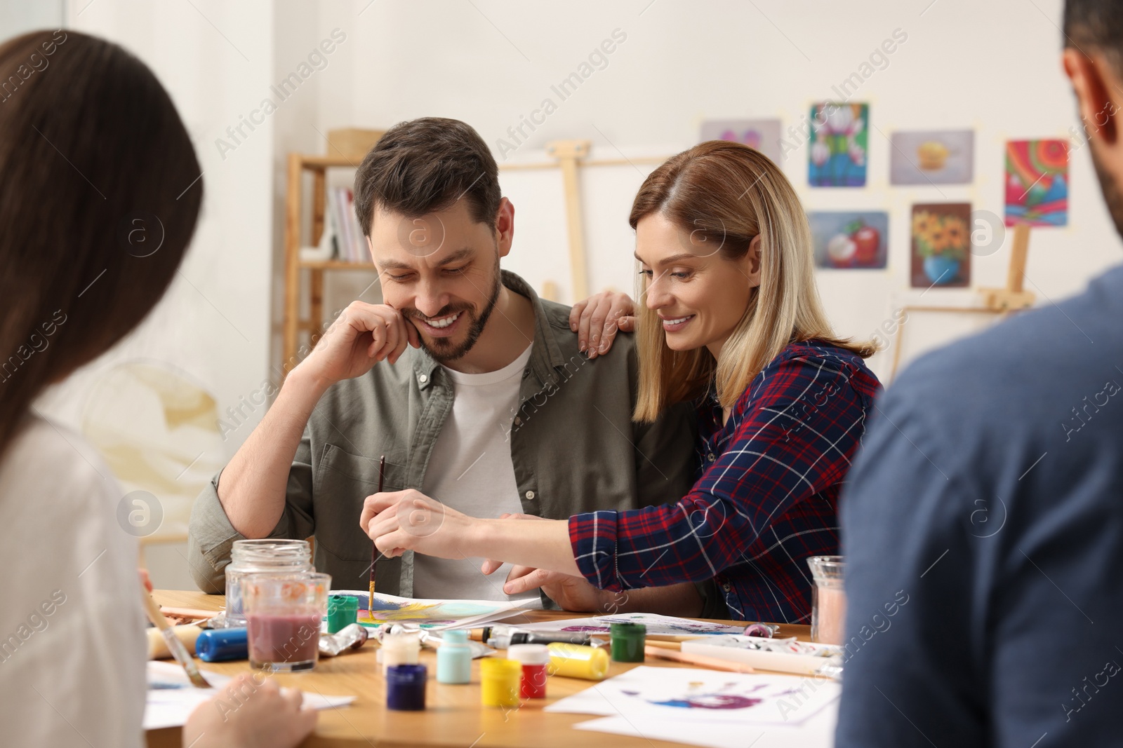 Photo of Group of students attending painting class in studio. Creative hobby