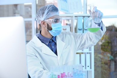 Photo of Young scientist working in laboratory. Chemical analysis