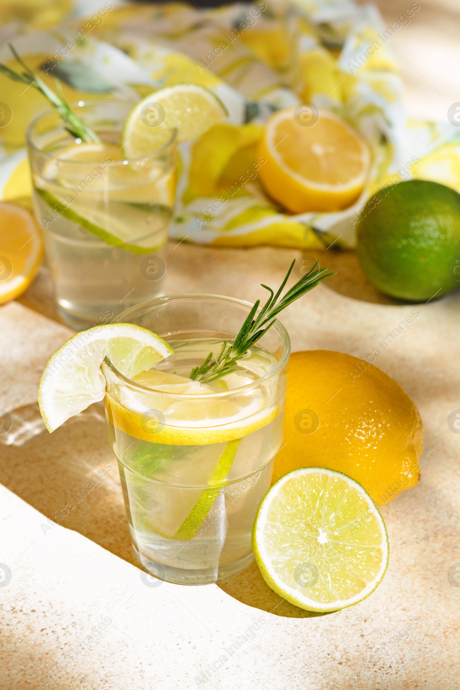 Photo of Tasty summer refreshing lemonade and ingredients on light table