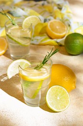 Tasty summer refreshing lemonade and ingredients on light table