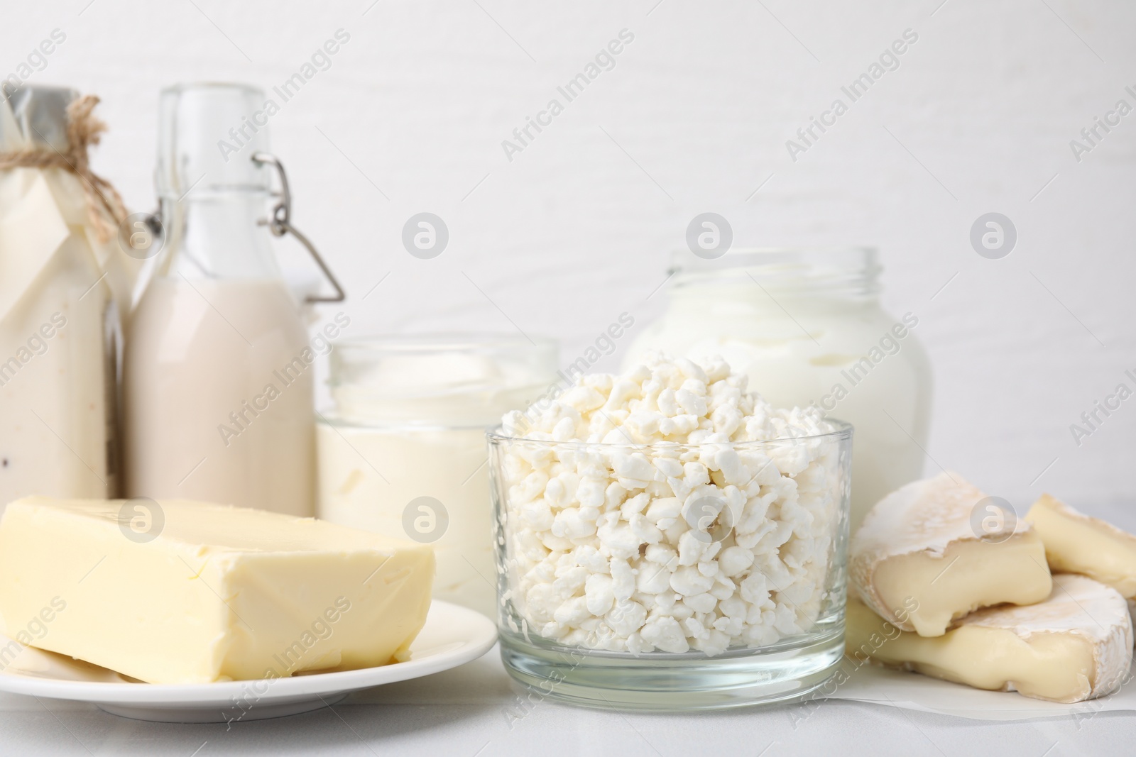 Photo of Different fresh dairy products on white table