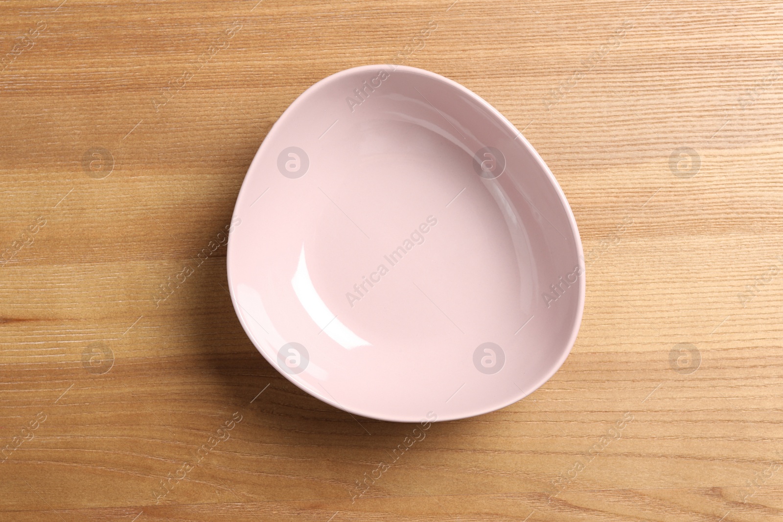 Photo of New empty bowl on wooden table, top view