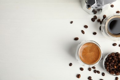 Photo of Tasty coffee and beans on white wooden table, flat lay. Space for text