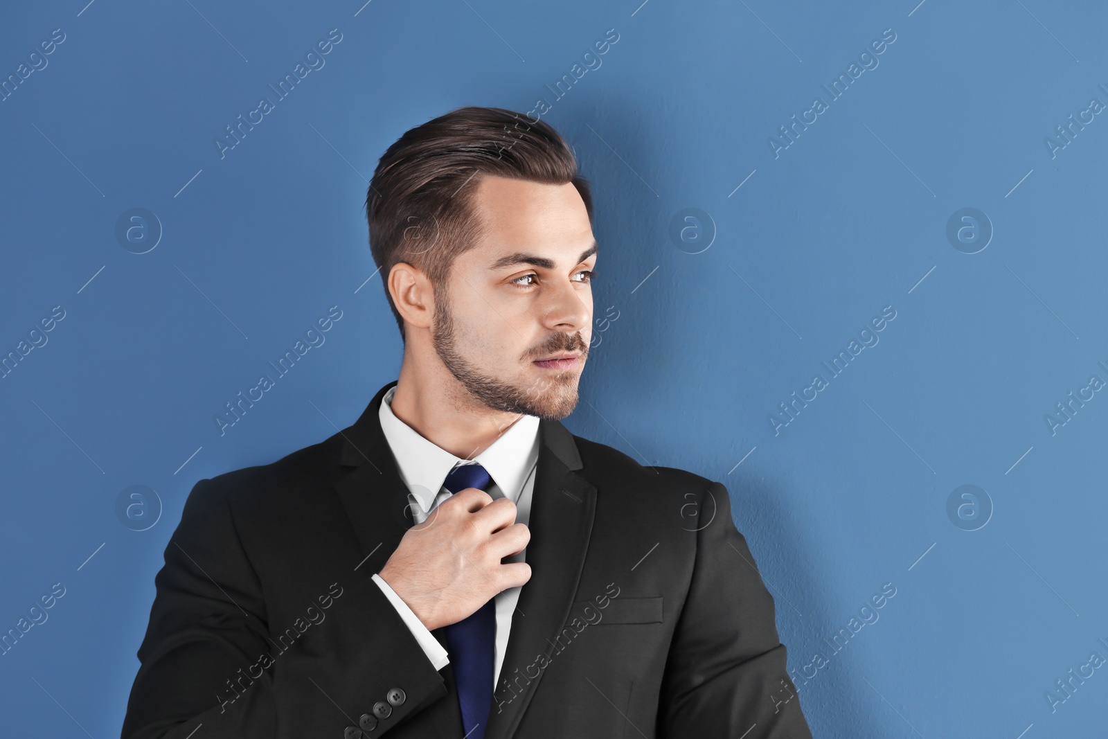 Photo of Portrait of young man with beautiful hair on color background