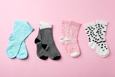 Flat lay composition with cute child socks on color background